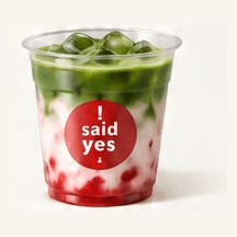 Iced Strawberry Matcha Latte: green matcha over milk with fresh strawberry at the base