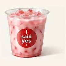 Iced Strawberry Milk: pink milk with fresh strawberry pieces in a clear cup